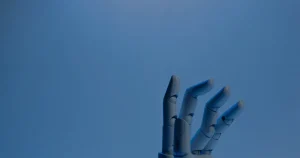 Mão robótica azul ilustrando a automação de segurança que protege a empresa em tempo real