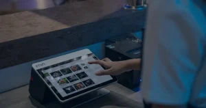 Mão em tela sensível ao toque ilustrando como a gestão de TI impacta a satisfação do cliente